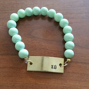 XO goldtone plate & mint beaded stretchy bracelet